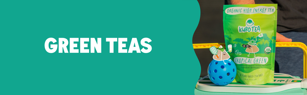A green tea pouch labeled Tropical Green and a small blue decorative tea holder sit on a white tray against a teal background with the words GREEN TEAS in large white text.